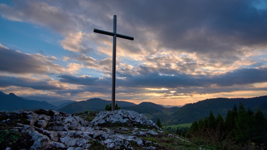 Christian Cross On A Rock At Sunset, colour clouds, fast moving clouds. 4K Royalty-Free Stock Footage #1089831165