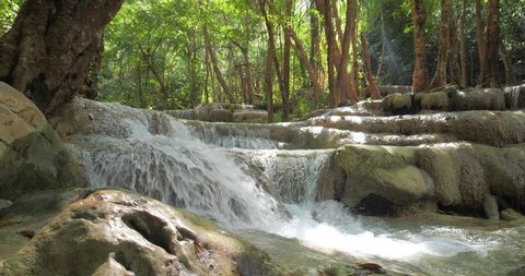 Waterfall clear emerald water for holiday relax travel in green jungle or forest at Erawan Waterfall, Erawan National Park in Kanchanaburi, Thailand