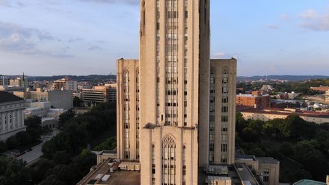 An aerial zoom out establishing shot of the Cathedral of Learning on Pitt's campus in Pittsburgh's Oakland district in late summer.