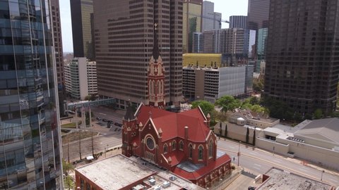Dallas , United States - 04 10 2022: Aerial view of the Cathedral Shrine of the Virgin of Guadalupe, in middle of buildings in Downtown, Dallas, USA