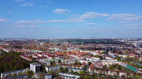 high up as a panorama slowly descending along trees ending in the park Beautiful aerial view flight drone footage of Berlin Tempelhof Park District Spring 2022. Cinematic view above by Philipp Marnitz