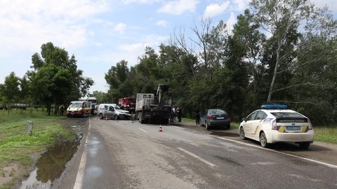 A truck and a car collided on the highway. Severe accident. Traffic accidents on the road. Traffic jam. DNIPRO, UKRAINE – August 11, 2021
