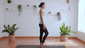 Yoga class at home, happy of young asian woman practicing yoga stretching in Lord of the Dance pose, Yoga and meditation have good benefits for health and wellness. Fitness, sport and healthy concept