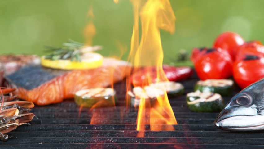Super slow motion of mix of sea food, fish and vegetable on grill grid. Filmed on high speed camera, 1000 fps