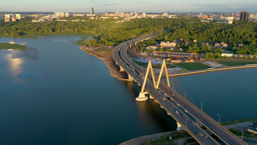 Panoramic summer footage of Millenium bridge. Tatarstan, Russia. Kazan city capital. City centre and landmark line with sunny weather. Sights, churches and mosque. River and cars. Travel destination
