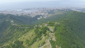 Inscription on video. Genoa, Italy. Forte Sperone is a key point of the 19th-century Genoese fortifications and is located on top of the Mura Nuove. View of Genoa. Text furry, Aerial View, Point of i