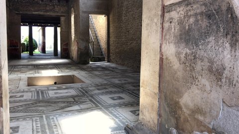 Pompeii, Naples - APR16, 2022: Pompeii beautiful mosaic tile floor inside ruins in Pompeii, Italy.