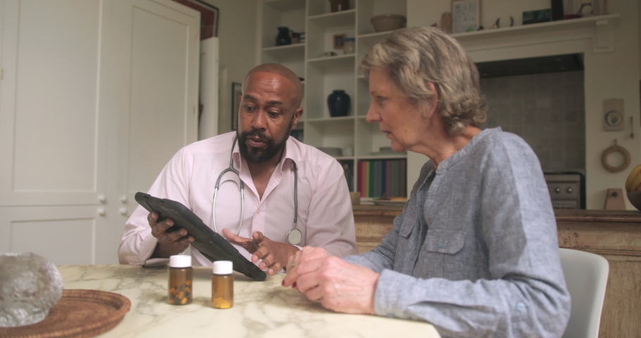 Doctor Explaining Medicine dosage to Senior Patient on Home Healthcare Visit | Shutterstock HD Video #1089844311