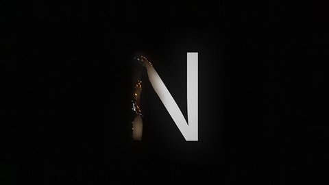 The letter N smolders and burns on a black background, the letter is on fire