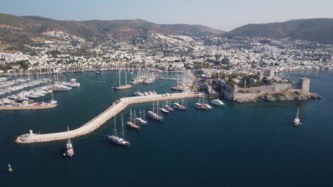 Bodrum, Turkey - October 18, 2021: Awesome aerial view of Bodrum Castle and Bodrum Harbor. Drone flying over the sea. The port city is a popular tourist destination in the Turkish Riviera.