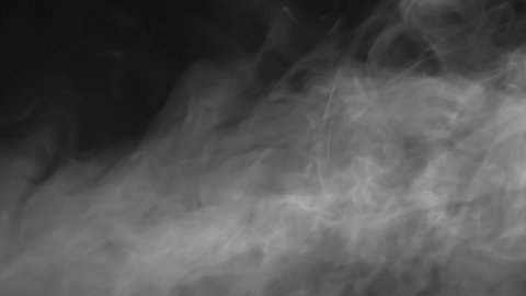 Shroud of Light White Smoke Slowly Settles. A veil of white smoke moves slowly on a black background