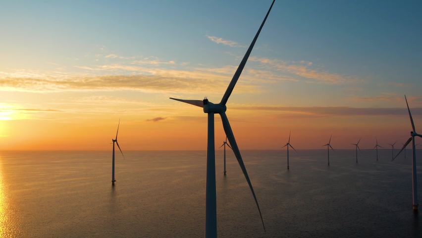 Working offshore wind farm, sunset view. Aerial view of Windpark with wind turbines, windmills. Concept: power plant, climate change, sustainable resources, green energy. Royalty-Free Stock Footage #1089850875