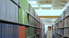 College student depressed and overwhelmed by a large stack of text books for studying in library  - Powered by Shutterstock - Get 15% off with code: PIKWIZARD15