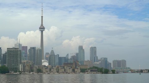 Toronto, Ontario, Canada - June 2019: Toronto Skyline view from island park. Toronto harbor skyline with CN Tower skyscrapers and moored yachts. Urban architecture.