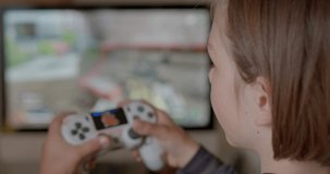 Child plays video games after school, kid spends too much time playing games. Action game can boost cognitive abilities perception, attention, and reaction time. 