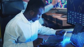 African-american stockbroker is analyzing stock rates. Investment, financial, business concept. - Powered by Shutterstock - Get 15% off with code: PIKWIZARD15