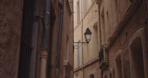 Cinematic view panning across the narrow alleyways of Montpellier France. 