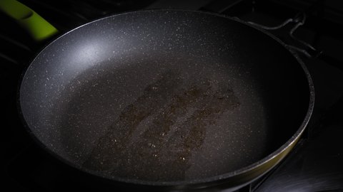 Greasing Hot Cast Iron Pan With Butter Before Pouring Eggs For Frying. close up