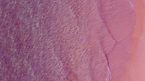 Aerial view of drone. Scene of Pink beach top view beach and pink seawater on sandy beach in summer. Nature and travel concept.