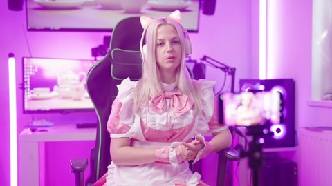 Pink lolita maid influencer gamer recording video with smartphone 4K