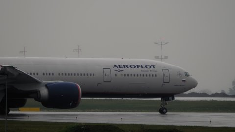 MOSCOW, RUSSIAN FEDERATION - JULY 28, 2021: Passenger jet Boeing 777 of Aeroflot airline goes to the runway on a wet taxiway after rain at Sheremetyevo airport