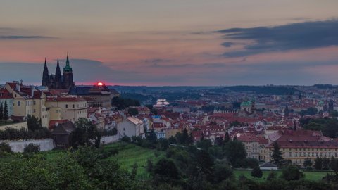 A beautiful view of Prague at sunrise on a misty morning timelapse. A panorama of Prague Old Town with majestic Prague Castle and St. Vitus Cathedral on the left and a golden rising sun in the