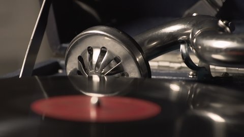 Using a magnetic cartridge on a phonograph to play classical music on vinyl. Placing a pickup cartridge on a vinyl with classical music. Listening to classical music on vinyl using on an old turntable