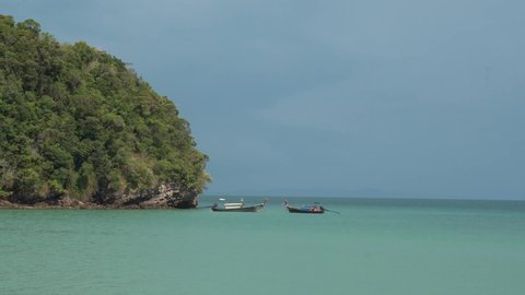 Landscape of Andaman sea and traditional long tail boat  with limestone in Railay Ao nang Krabi Thailand - sunny day summer
