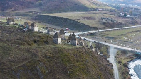 Drone flying above ruins high angle camera moving down, Dargavs, Northern Ossetia, Russia