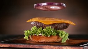 Beef Burger Ingredients Falling and Landing in the Bun. Super Slow Motion at 1000 fps. - Powered by Shutterstock - Get 15% off with code: PIKWIZARD15