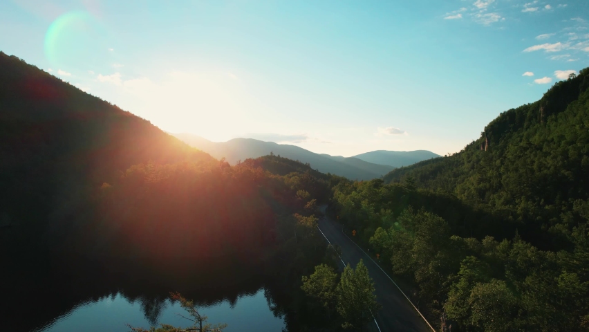 Breathtaking Aerial Of Road At Adirondack Mountains, USA. Blue Sky Sunset.