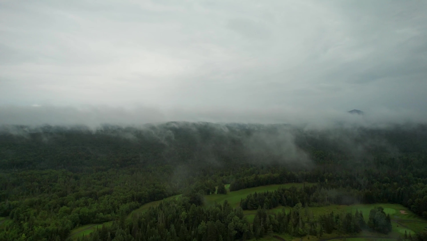 Flying Through Clouds 4K Aerial Above Forest Of The Adirondack Mountains.