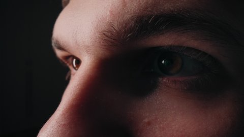 Extremely close-up of a man's eyes, which reflect the ideas of innovation and simplicity of virtual reality. Fire burns in the eyes