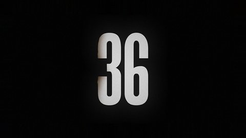 The number 36 smolders and burns on a black background, the number is on fire
