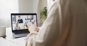 Young asia female listen leader on video call with diverse multiracial colleagues on online with laptop in kitchen at house. Girl student distance learn online at house, Online meeting concept.