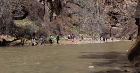 Springdale, Utah, USA - April 2022: Hikers wear drysuits to complete "The Narrows" hike, a popular trail in Zion National Park.