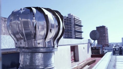 Air Spinning Turbine Ventilator for Heat Control of Residential Building in Buenos Aires, Argentina. Close-Up. 4K Resolution.