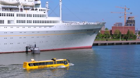 Rotterdam, Netherlands - April 28, 2022: Splashtours offers guided tours of Rotterdam in a bright yellow amphibian bus