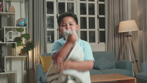 Asian Little Boy Shows Trick With Disappearing While Making Video Content For Social Networks In Cozy Room
