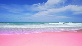 Amazing summer sea background. ocean blue waves break on pink sand beach waves crashing against an empty beach.Sea waves and beautiful pastel color romantic sand beach High quality video