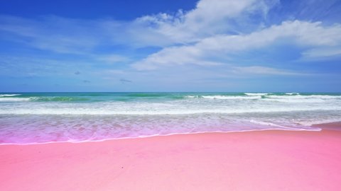 Amazing summer sea background. ocean blue waves break on pink sand beach waves crashing against an empty beach.Sea waves and beautiful pastel color romantic sand beach High quality video