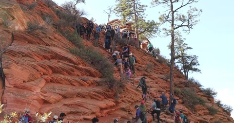 Springdale, Utah, USA - March 31, 2022: Crowds gather to hike up to Angels Landing, a popular and dangerous hike in Zion National Park. A limited entry system was implemented one day later.
