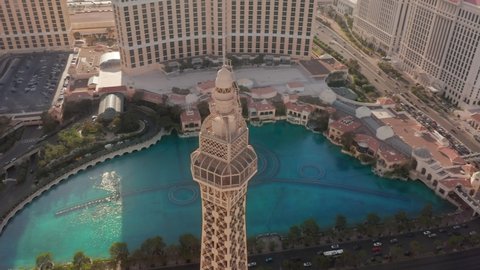 Paris hotel aerial, Las Vegas city, USA, Apr 2022. Cinematic drone footage view of restaurant on top Eiffel tower landmark. Drone flying around on sunny summer day with Vegas on motion background 4K