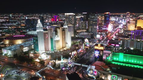 Las Vegas Strip Nevada, Apr. 2022. Cinematic aerial of scenic New York hotel with Liberty Statue and roller coaster at night illumination. Entertainment gambling capital, holiday travel concept 4K