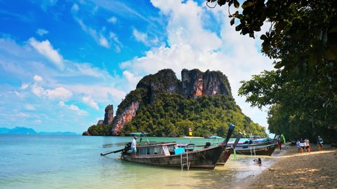 Krabi, Thailand - circa 2020: Rows of traditional thai boats on beach. Tropical island paradise view of thailand travel resort near Krabi and Phang Nga