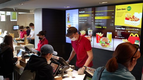 Counter service in a McDonald's restaurant. People order food at McDonald's restaurant. McDonald's is an American hamburger and fast food restaurant chain. Minsk, Belarus - may, 2022