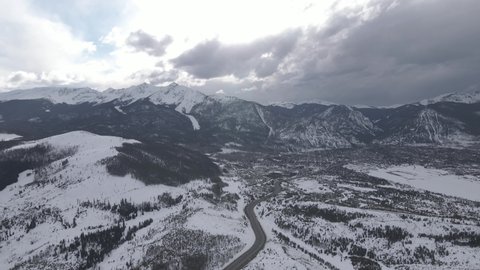 Aerial View of Keystone Ski Resort, Colorado USA on Winter Season, Clouds Above Hills and Village, Drone Shot