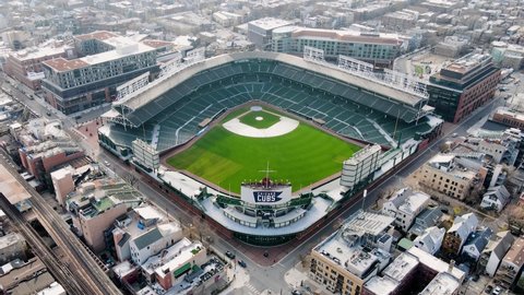 Chicago , United States - 04 03 2022: Aerial view away from the Wrigley Field, Home of the Chicago Cubs - pull back, drone shot