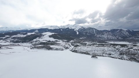 Aerial View of Frozen Dillon Lake, Water Reservoir Under Keystone Ski Center, Colorado USA