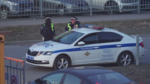 SAINT PETERSBURG, RUSSIA - CIRCA APRIL, 2022: Police officers writing traffic ticket to upset female driver, Russian police traffic cops at work.